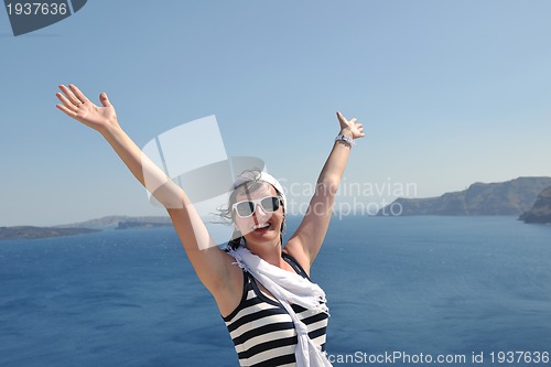 Image of Greek woman on the streets of Oia, Santorini, Greece