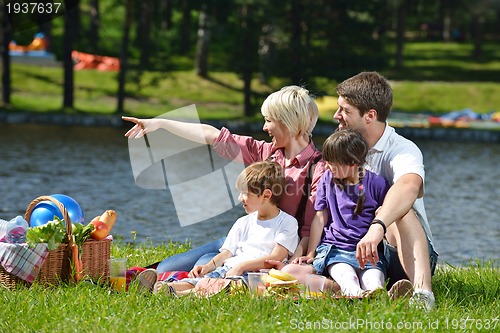 Image of Happy family playing together in a picnic outdoors