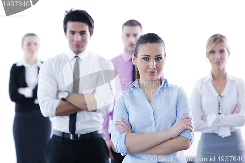 Image of business woman standing with her staff in background