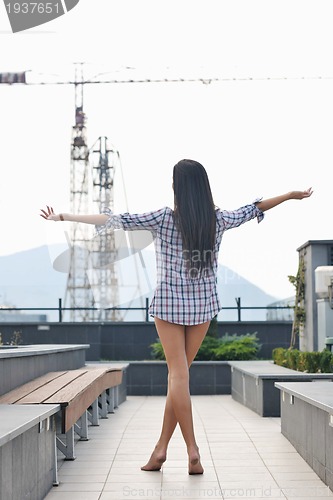 Image of beautiful young lady posing in garden
