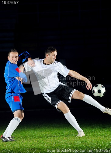 Image of football players in action for the ball