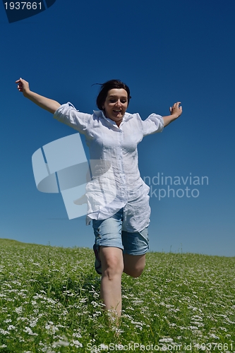 Image of Young happy woman in green field