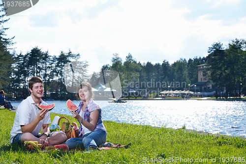 Image of happy young couple having a picnic outdoor