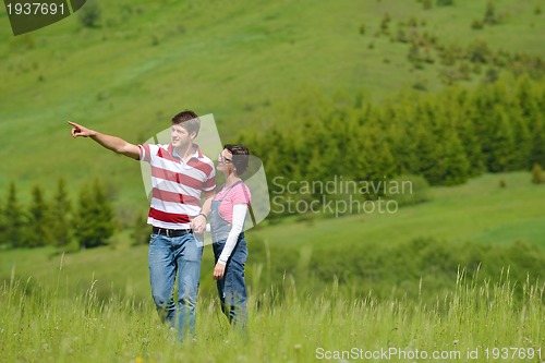 Image of Portrait of romantic young couple smiling together outdoor