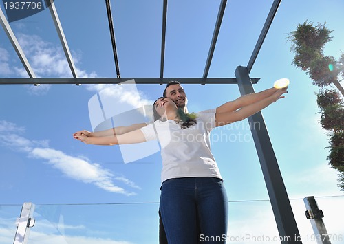Image of couple relaxing on balcony