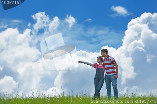 Image of Portrait of romantic young couple smiling together outdoor