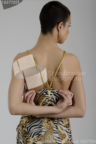 Image of elegant woman in fashionable dress posing in the studio