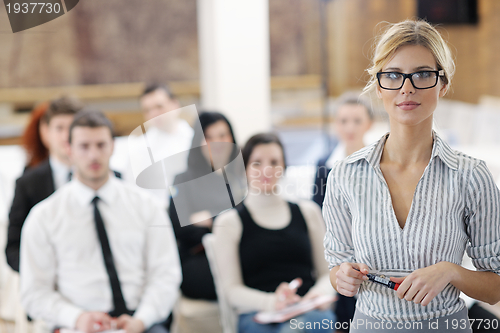 Image of business woman standing with her staff at conference