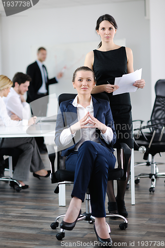 Image of business woman with her staff in background