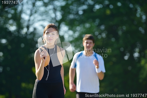 Image of Young couple jogging at morning