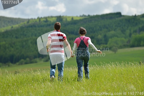 Image of Portrait of romantic young couple smiling together outdoor