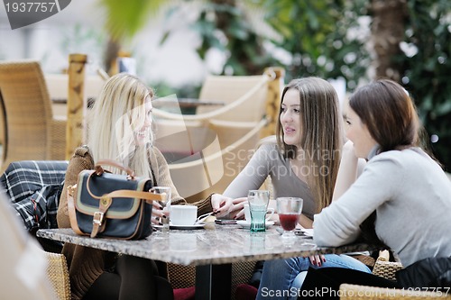 Image of cute smiling women drinking a coffee