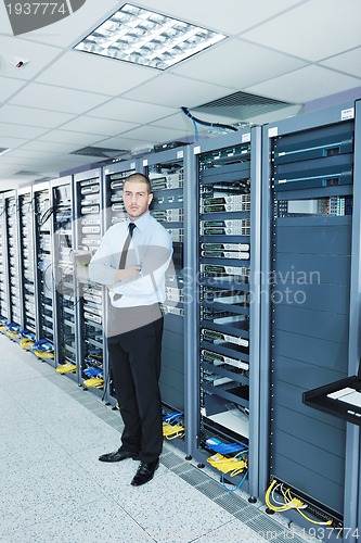 Image of young it engeneer in datacenter server room