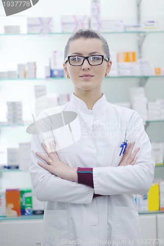 Image of pharmacist chemist woman standing in pharmacy drugstore