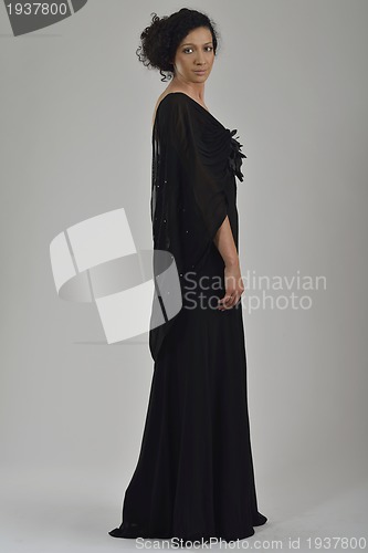 Image of elegant woman in fashionable dress posing in the studio