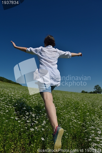Image of Young happy woman in green field