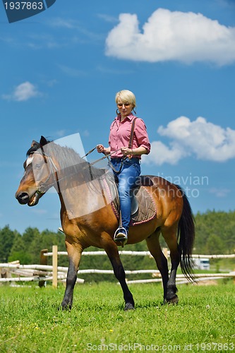 Image of happy woman  ride  horse