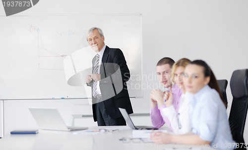 Image of Senior business man giving a presentation