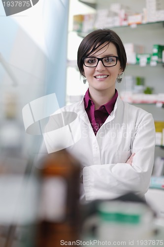 Image of pharmacist chemist woman standing in pharmacy drugstore