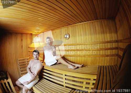 Image of happy young couple in sauna