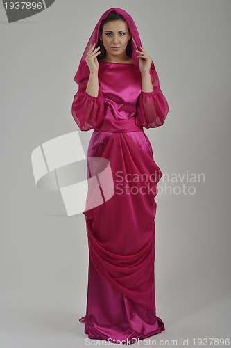 Image of elegant woman in fashionable dress posing in the studio