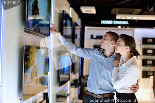 Image of Young couple in consumer electronics store
