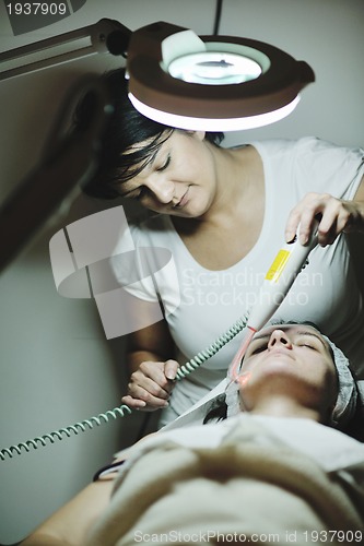 Image of woman with facial mask in cosmetic studio