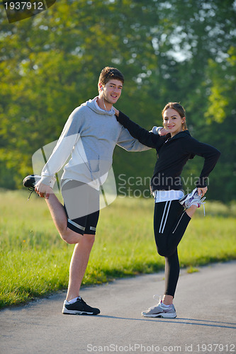 Image of Couple doing stretching exercise  after jogging