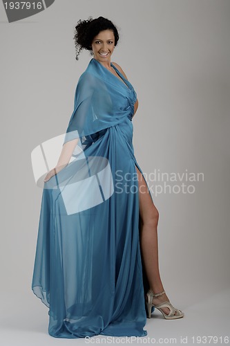 Image of elegant woman in fashionable dress posing in the studio