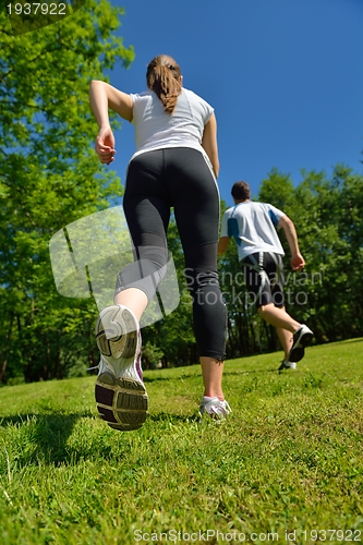 Image of Young couple jogging at morning