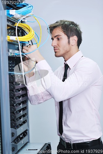 Image of young it engeneer in datacenter server room