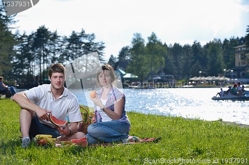 Image of happy young couple having a picnic outdoor