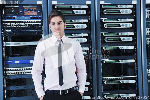 Image of young it engineer in datacenter server room