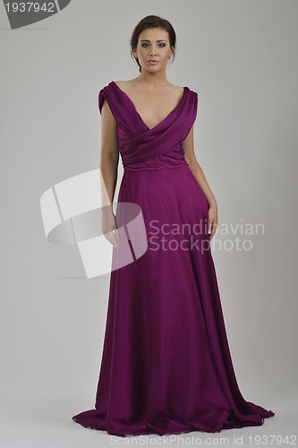 Image of elegant woman in fashionable dress posing in the studio