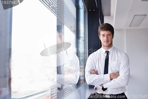 Image of Young pretty business woman with notebook in the office