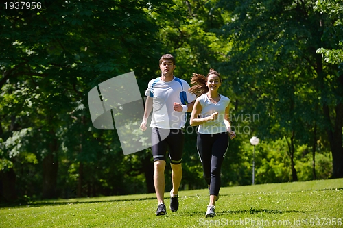 Image of Young couple jogging