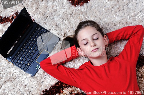 Image of happy school girl relaxing at home