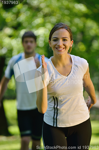 Image of Young couple jogging at morning