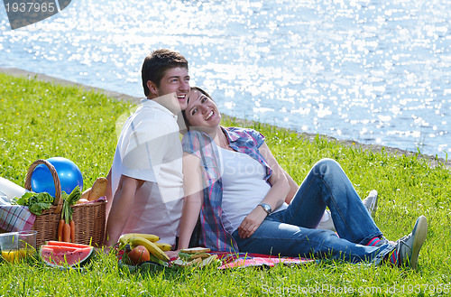 Image of happy young couple having a picnic outdoor