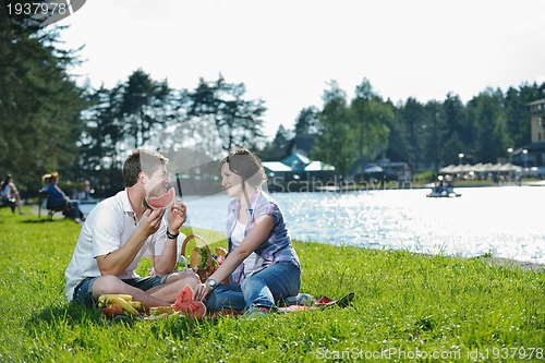 Image of happy young couple having a picnic outdoor