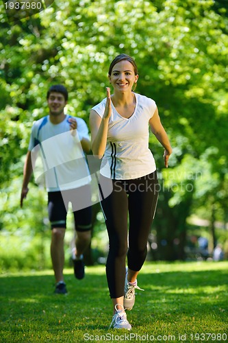 Image of Young couple jogging at morning