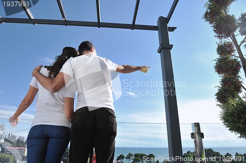 Image of couple relaxing on balcony