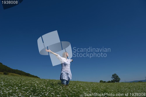 Image of young woman in wheat field at summer