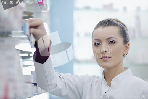Image of pharmacist chemist woman standing in pharmacy drugstore