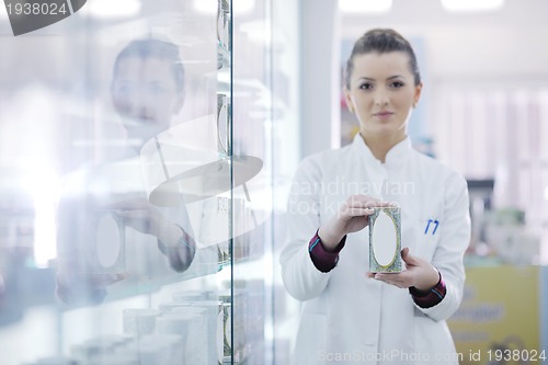 Image of pharmacist chemist woman standing in pharmacy drugstore