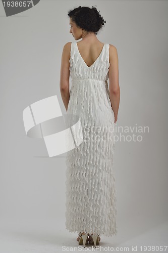 Image of elegant woman in fashionable dress posing in the studio