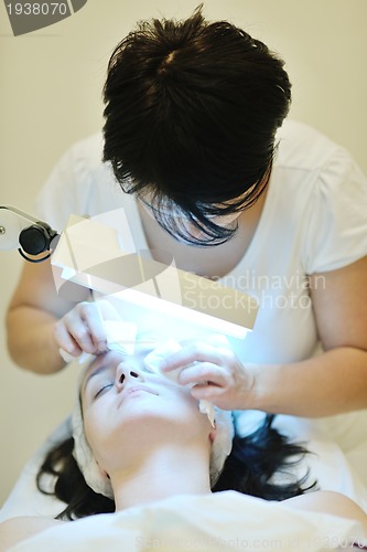 Image of woman with facial mask in cosmetic studio