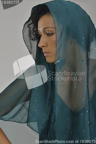 Image of elegant woman in fashionable dress posing in the studio