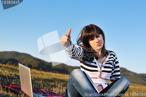 Image of young teen girl work on laptop outdoor