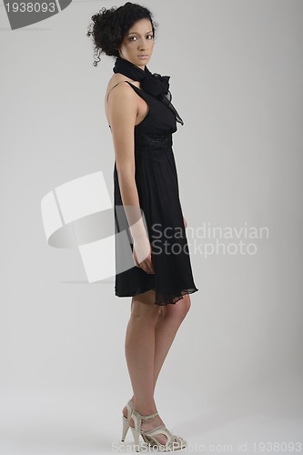 Image of elegant woman in fashionable dress posing in the studio